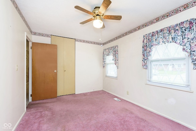 unfurnished bedroom featuring carpet flooring, ceiling fan, and a closet