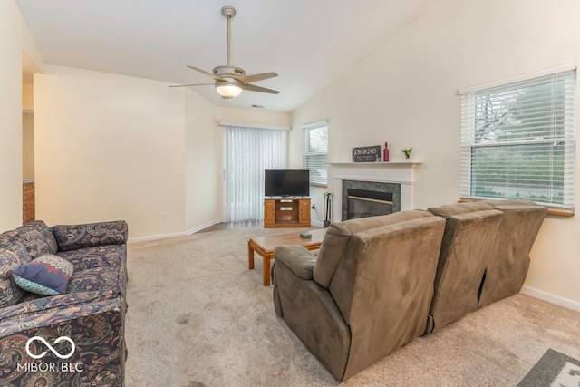 carpeted living room with a premium fireplace, ceiling fan, and lofted ceiling