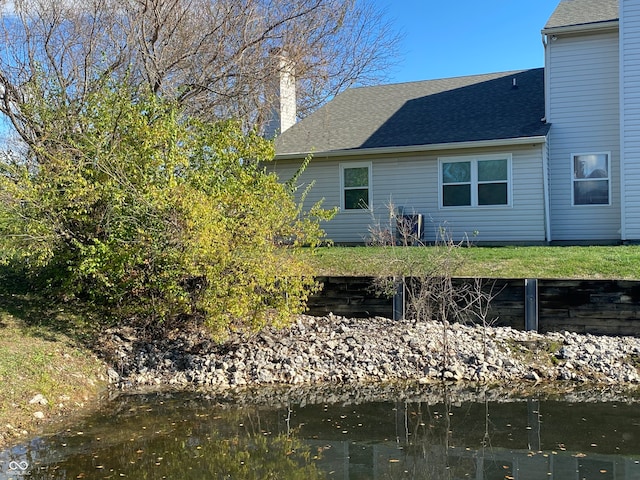 back of property featuring a water view