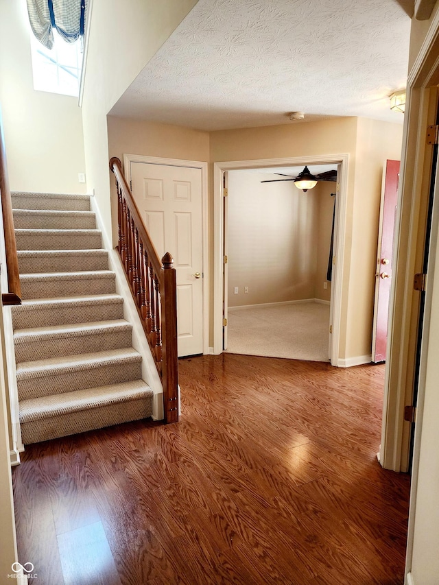 foyer with hardwood / wood-style flooring and a textured ceiling