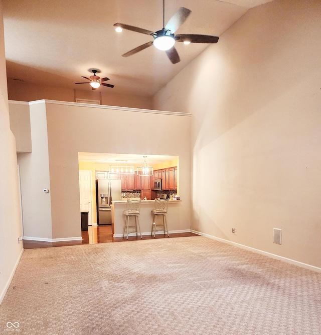 4835 Franklin Villas Dr, Indianapolis, IN 46237 - unfurnished living room with ceiling fan, light carpet, and high vaulted ceiling