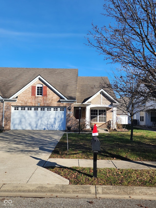 view of front of property with a garage and a front lawn