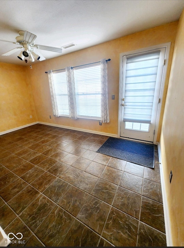 doorway featuring ceiling fan