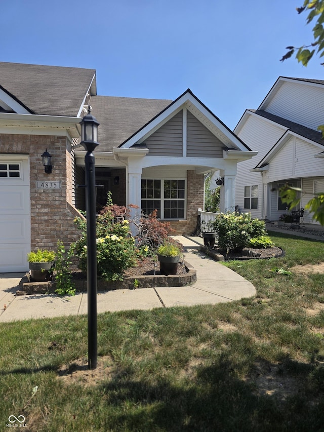4835 Franklin Villas Dr, Indianapolis, IN 46237 - view of front of property featuring a front yard, a shingled roof, and brick siding