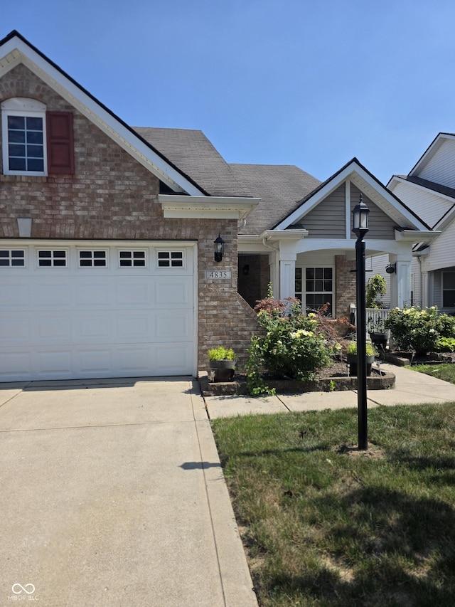 4835 Franklin Villas Dr, Indianapolis, IN 46237 - view of front facade featuring brick siding, driveway, roof with shingles, and a garage