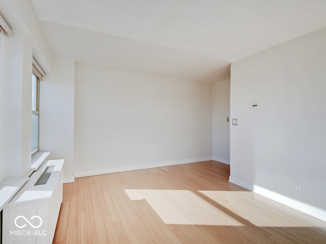 unfurnished room with light hardwood / wood-style floors