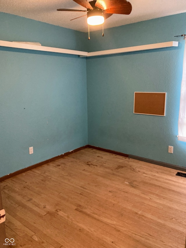 unfurnished room featuring wood-type flooring, a textured ceiling, and ceiling fan