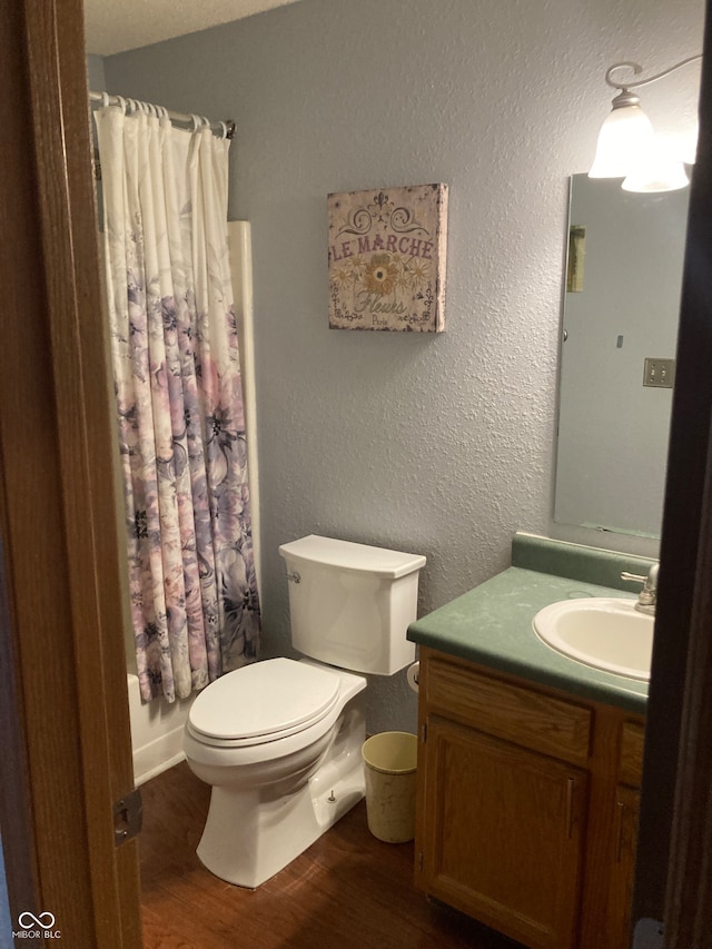 full bathroom featuring wood-type flooring, vanity, toilet, and shower / bath combo