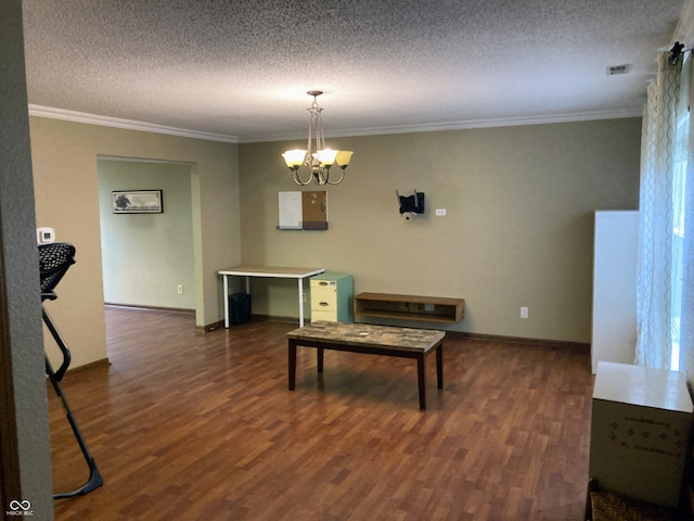 dining space with ornamental molding, dark wood-type flooring, a textured ceiling, and an inviting chandelier