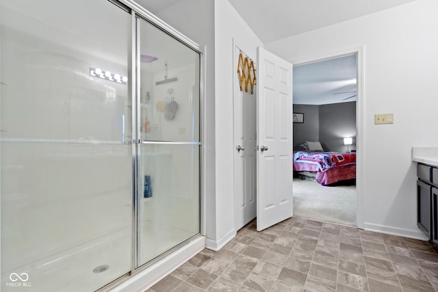 bathroom with vanity and a shower with door