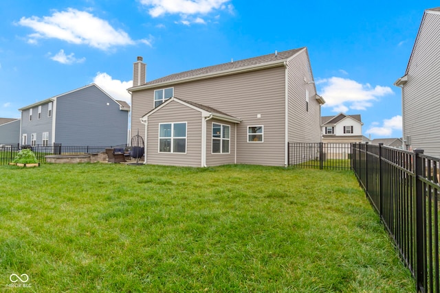 back of house featuring a yard