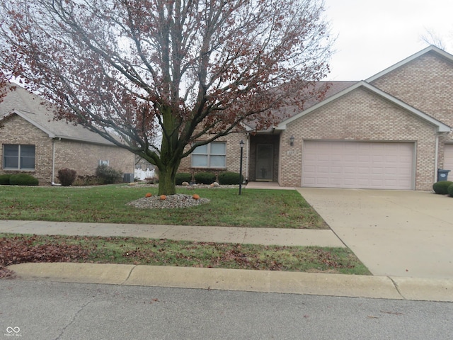 single story home featuring a garage and a front lawn