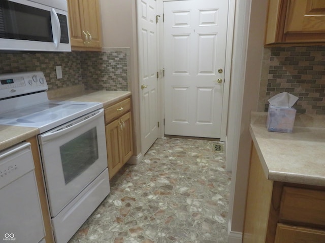 kitchen with white appliances and tasteful backsplash