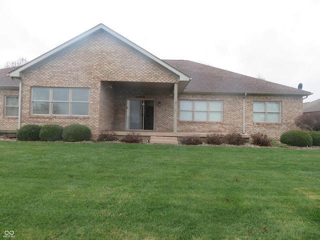 rear view of house featuring a lawn