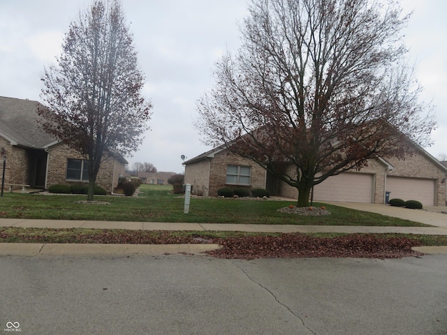 view of front of house featuring a garage and a front lawn