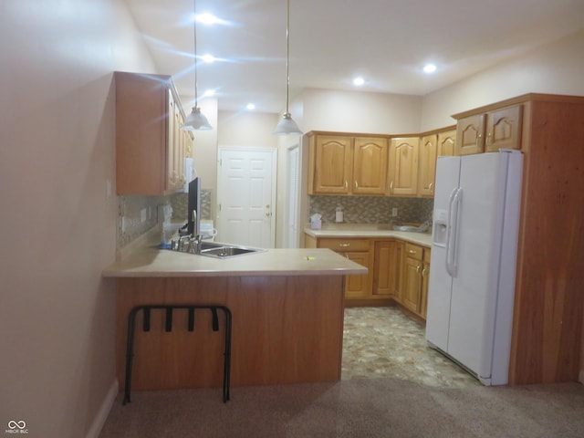 kitchen with sink, white refrigerator with ice dispenser, kitchen peninsula, decorative light fixtures, and decorative backsplash