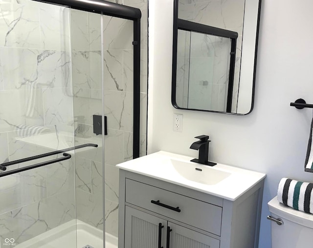 bathroom with vanity, toilet, and an enclosed shower