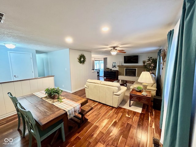 dining area featuring wood-type flooring and ceiling fan