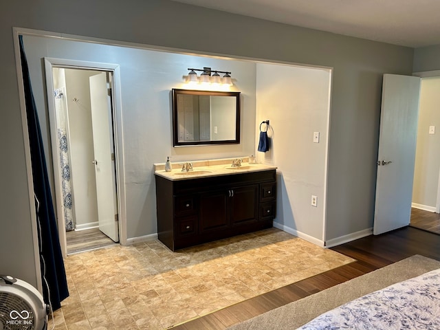 bathroom featuring hardwood / wood-style flooring and vanity