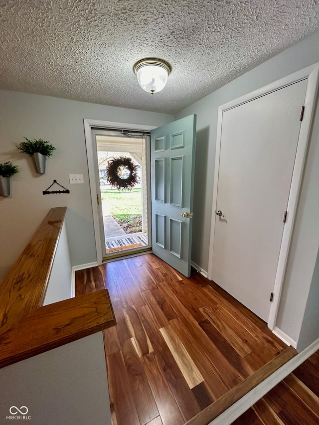 foyer with hardwood / wood-style flooring and a textured ceiling