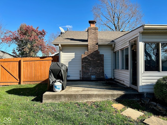 view of side of property featuring a yard and a patio
