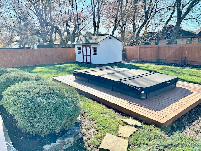 view of yard with a covered hot tub, a storage unit, and a deck