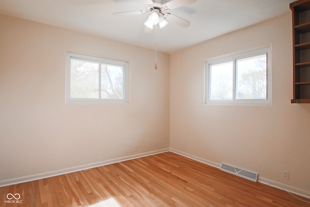 empty room with light hardwood / wood-style flooring and ceiling fan