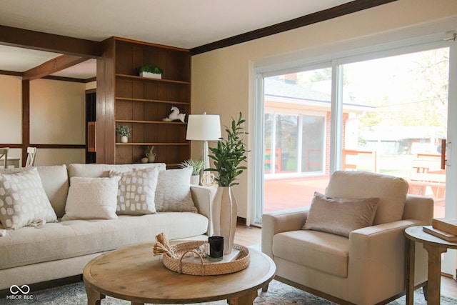 living room with beam ceiling and crown molding