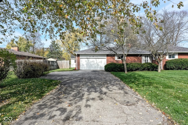 ranch-style home with a garage and a front lawn