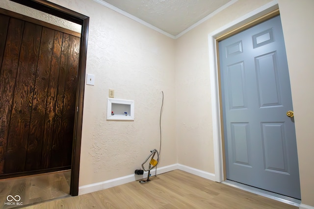 washroom featuring light hardwood / wood-style flooring, washer hookup, and ornamental molding