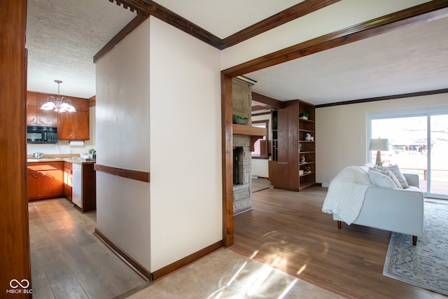 corridor with a chandelier, dark hardwood / wood-style floors, and crown molding