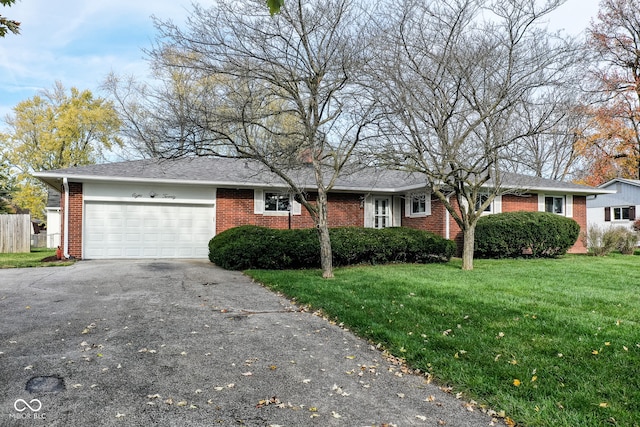 single story home featuring a garage and a front yard