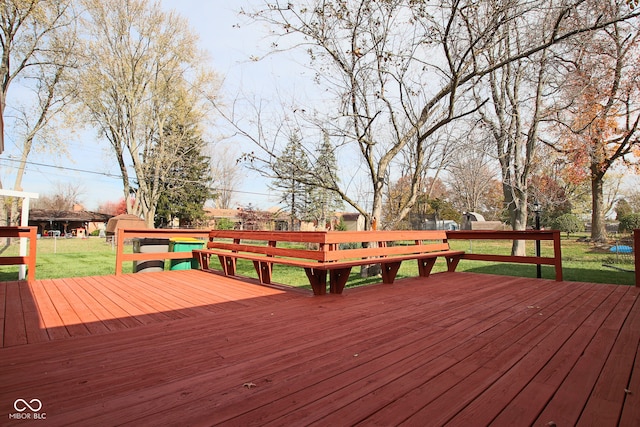 wooden deck with a lawn