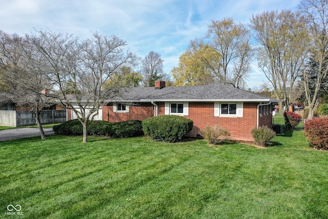 view of side of home with cooling unit and a yard