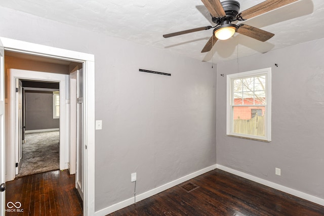 unfurnished room featuring ceiling fan and dark hardwood / wood-style flooring