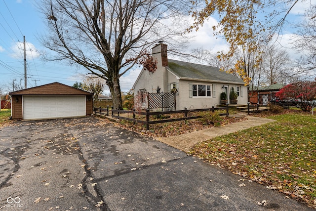 view of property exterior featuring a garage and an outbuilding