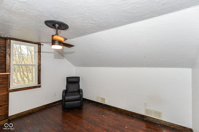 unfurnished room with a textured ceiling, lofted ceiling, ceiling fan, and dark hardwood / wood-style floors