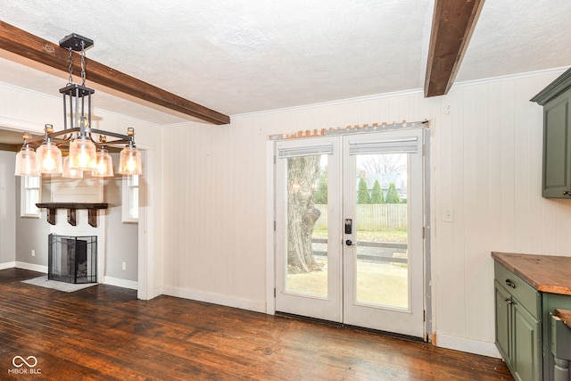 entryway with french doors, wooden walls, ornamental molding, beam ceiling, and dark hardwood / wood-style flooring