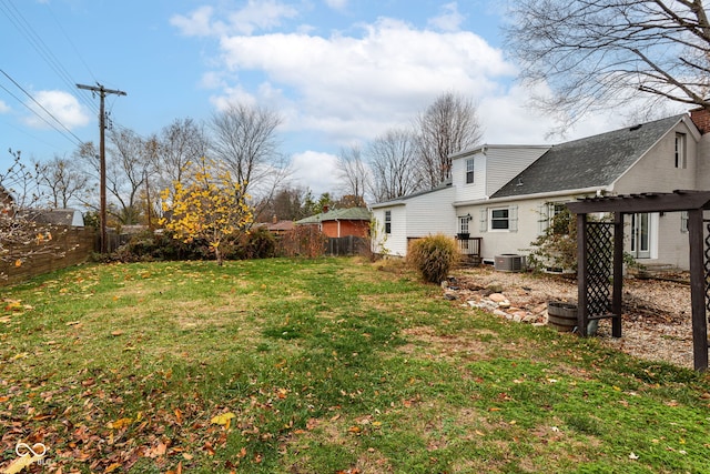 view of yard with a pergola and central AC