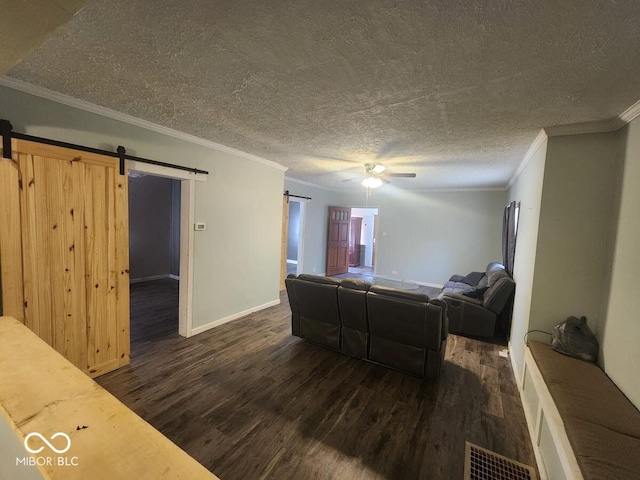 306 E Cherry St, Advance, IN 46102 - living area featuring a barn door, dark wood-style floors, ornamental molding, a ceiling fan, and baseboards