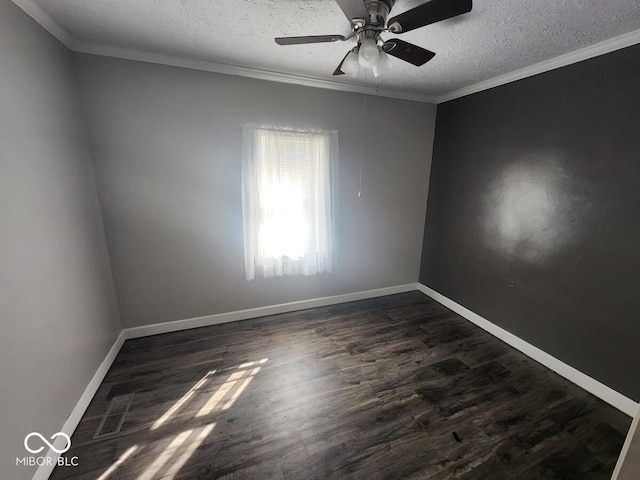 spare room featuring a textured ceiling, ceiling fan, dark hardwood / wood-style floors, and ornamental molding