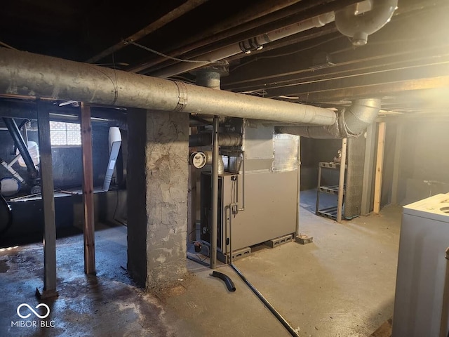 basement with washer / dryer and heating unit