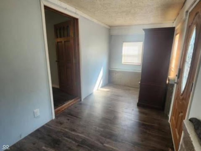 hallway featuring a textured ceiling and dark hardwood / wood-style flooring