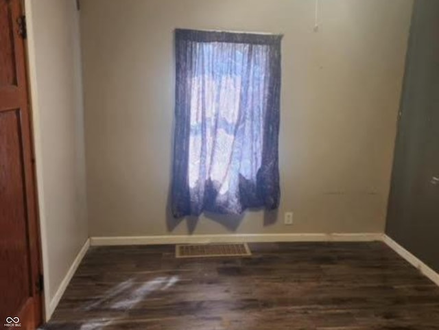 spare room with dark wood-type flooring