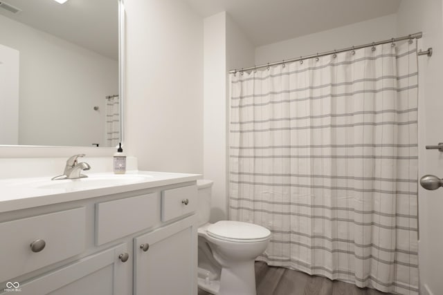 bathroom featuring vanity, hardwood / wood-style floors, and toilet