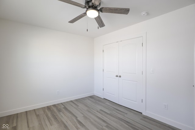 unfurnished bedroom with a closet, ceiling fan, and light wood-type flooring