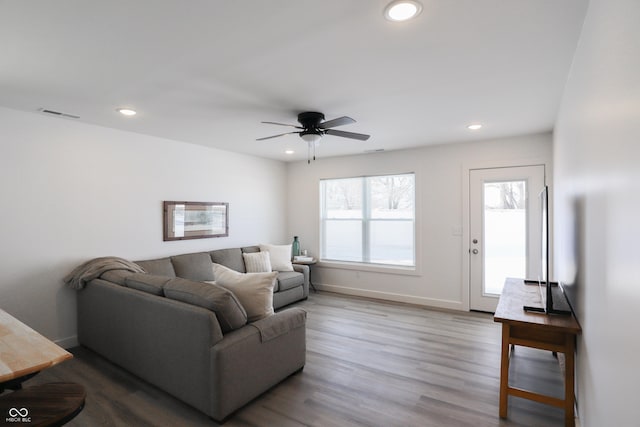 living room featuring hardwood / wood-style flooring and ceiling fan