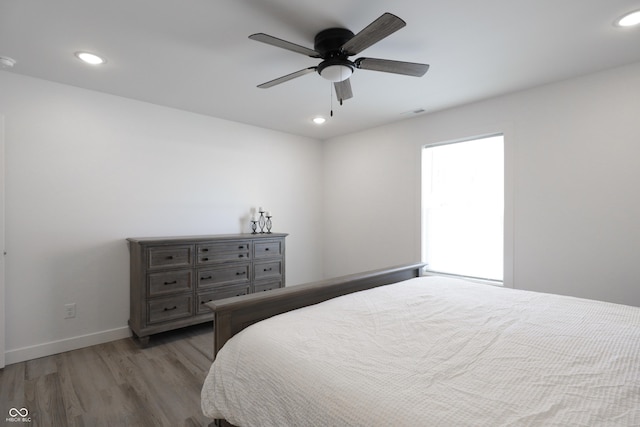 bedroom with ceiling fan and wood-type flooring