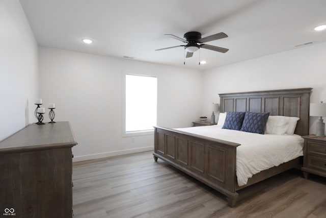 bedroom with ceiling fan and light hardwood / wood-style flooring