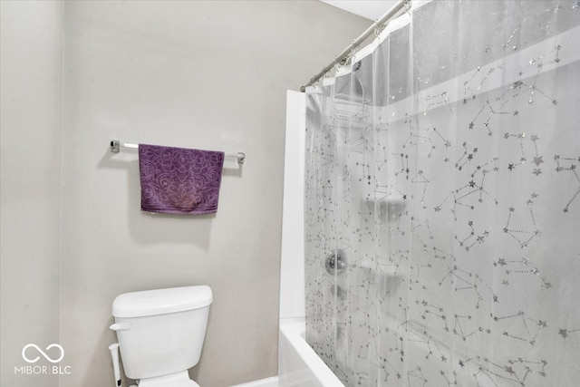 bathroom with shower / bath combination with curtain and toilet